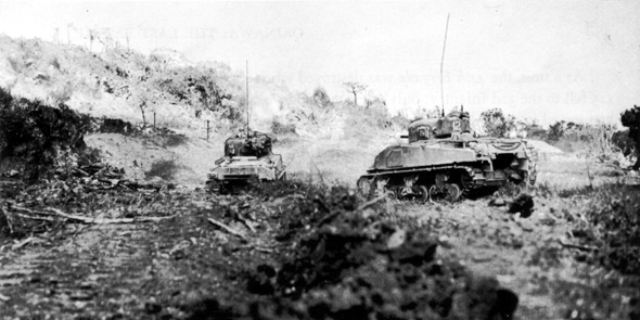  FIGHTING TOWARD HILL 89, tanks of the 769th Tank Battalion attack a bypassed Japanese strong point on top of Yaeju-Dake, 18 June 1945