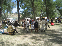 Photo:  The Soldiers of the Corps of Discovery prepare to train some new recruits who came to Pompey’s Pillar to “enlist.”  The re-enactors are members of the “Captain Lewis’ Company,” comprised of volunteer civilian employees of Army Corps of Engineers and members of the Frontier Army Museum Living History Association, accurately portray the military nature and mission of the Corps.