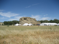 Photo:  The Corps of Discovery reached Pompey's Pillar on July 25, 1806. Pompey's Pillar National Monument, a National Historic Landmark, is managed by the Bureau of Land Management, U.S. Department of the Interior. The Pillar overlooks the Yellowstone River about 25 miles east of Billings, Montana. The tents belonging to Federal Interagency Working Group participants and commercial vendors were temporarily erected at Pompey’s Pillar for the July 2006 Lewis and Clark National Signature Event.