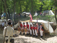 Photo:  Portraying “Field Musicks” of the 1 st US Infantry Regiment, the Lewis and Clark Fife and Drum Corps of St. Charles, Missouri, prepares to “sound off” upon arrival of the expedition at the Belle Fontaine Cantonment...