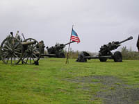 Photo: Salute batteries were arrayed on both the Washington State and Oregon sides of the Columbia River to commemorate the opening ceremony.  In this photo you can see the Oregon saluting battery which was composed of three modern 105mm howitzers and one Napoleon Brass 12-pounder of Civil War vintage on the rampart of Fort Stevens.