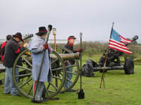 Photo: The gun crew of the Napoleon Brass 12-pounder goes through the motions of preparing to fire a blank charge.