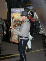 Photo: Private George Gibson, dressed in the uniform of a new recruit, playing his fiddle for the spectators in the Corps II portable exhibit hall known as the "Tent of Many Voices".