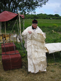 Photo: Walt Walker of the Montana Honor Guard demonstrates how the expedition attempted to cover the experimental iron framed boat with animal hides laid atop thin strips of wood.