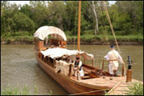 Photo: The replica Lewis and Clark keelboat moored at Boyer Chute National Wildlife Refuge, a satellite location of the 'First Council' Lewis and Clark signature event, July 31-August 3, 2004.  With their campsite established and pirogues beached nearby, the members of the St. Charles Corps of Discovery accurately portrayed the original Corps with 1804 military dress and drill.