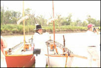 Photo: The replica Lewis and Clark red and white pirogues, moored at Boyer Chute National Wildlife Refuge, a satellite location of the 'First Council' Lewis and Clark signature event, July 31-August 3, 2004.  With their campsite established and the keelboat moored nearby, the members of the St. Charles Corps of Discovery accurately portrayed the original Corps with 1804 military dress and drill.