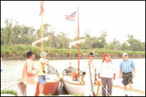 Photo: The replica Lewis and Clark red and white pirogues moored at Boyer Chute National Wildlife Refuge, a satellite location of the 'First Council' Lewis and Clark signature event, July 31-August 3, 2004.  With their campsite established and keelboat moored nearby, the members of the St. Charles Corps of Discovery accurately portrayed the original Corps with 1804 military dress and drill.