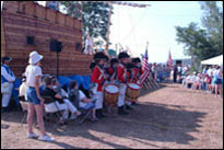 Photo: The 'Lewis and Clark Fife and Drum Corps' performing by the replica keelboat at the Lewis and Clark Bicentennial Commemoration, Fort Atkinson Corps of Discovery Festival, in Fort Calhoun, Nebraska, July 31-August 3, 2004.  The Corps, a youth group, authentically interprets the music, drill and uniforms of U.S. Army musicians during the Jefferson administration.