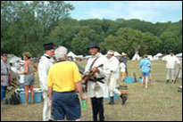 Photo: Members of ‘Captain Lewis’ Company’ from the U.S. Army Corps of Engineers and the frontier Army Museum, presenting first person ‘living history’ interpretations to visitors of the Nebraska Lewis and Clark Bicentennial Commemoration, Fort Atkinson Corps of Discovery Festival, in Fort Calhoun, Nebraska, July 31-August 3, 2004.