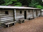 Photo: Enlisted men’s quarters constructed along the western wall of Fort Clatsop. 