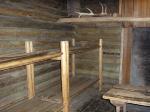 Photo: Interior view of the enlisted men’s quarters. Each room had a separate fireplace, which unfortunately cannot be seen in the modern reconstruction of Fort Clatsop. 