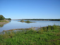 Photo: The Missouri River inlet at Fort Pierre, South Dakota where Lewis and Clark were confronted by some of the chiefs of the Lakota Sioux.  The official Army History of the expedition describes the event thusly:  'Early on Tuesday morning, 25 September 1804, on a sandbar in the mouth of the Bad River, the Corps of Discovery met the leaders of the Teton Sioux: Black Buffalo, the Grand Chief; the Partisan, second chief; Buffalo Medicine, third chief; and two lesser leaders.  Lewis and Clark presented them with gifts.  Unaware of factional Sioux politics, the captains inadvertently slighted two chiefs named 'the Partisan' and 'Buffalo Medicine'.  They complained that their gifts were inadequate.  After drinking some whiskey, the Partisan moved toward Clark, speaking roughly and staggering into him.  Determined not to be bullied, Clark drew his sword.  Suddenly, soldiers and Indians faced each other, arms at the ready.  Fortunately, everyone held their fire, permitting Lewis, Clark, and Black Buffalo to calm the situation.'