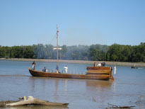Photo: The keelboat fires a salute from its cannon to announce its arrival at Fort Pierre, South Dakota. 