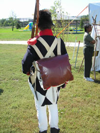 Photo: Back view of the same individual.  Some knapsacks were marked with a prominent “U.S.” in white.