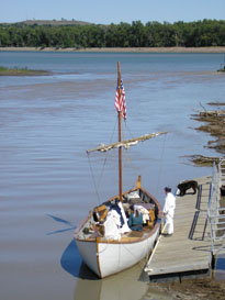 Photo: Another view of the white pirogue as seen from a footbridge spanning the Bad River.