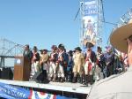 Photo: Period interpreters are arrayed behind Mayor of Louisville on reviewing stand after replica keelboat has landed.