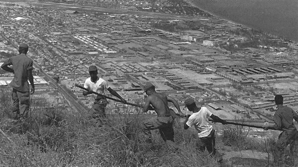 Photo:  Hauling the cable down the mountain with the city of Qui Nhon in the background