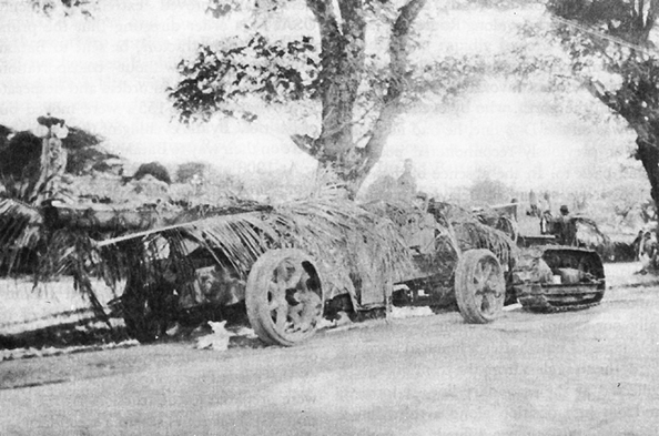 Photo:  Camouflaged 155-mm. gun M1917 (GPF), towed by a 10-ton tractor
