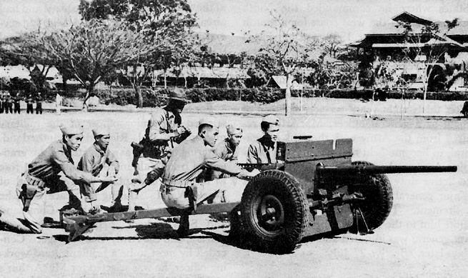 Photo:  Philippine Scouts at Fort McKinley firing a 37-mm. antitank gun in training