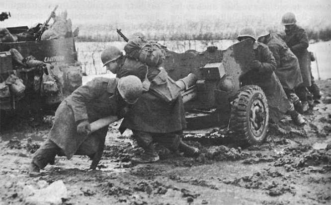 Photo:  Troops positioning antitank gun.