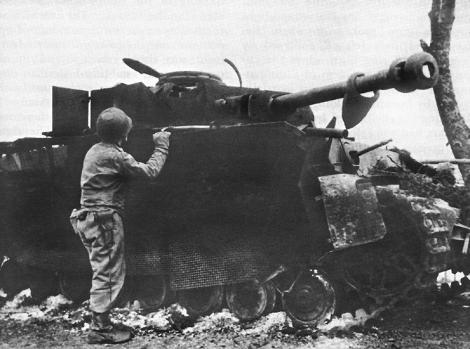 Photo:  Wrecked German tank showing "Bazooka Pants," a defense against rockets.
