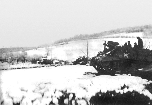 Photo:  105-mm. howitzers M7 of the 30th Division in action near La Gleize