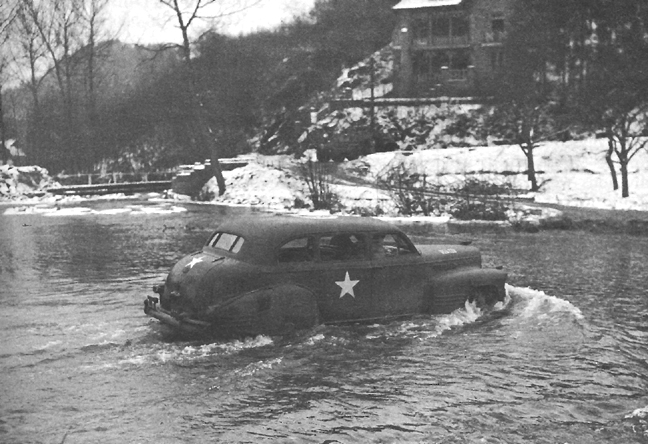 Photo:  Car bearing General Bradley fords a Belgian river