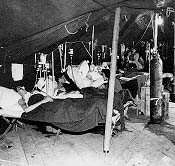 Army nurses at work in the postoperative ward, U.S. Army 10th Field Hospital, Grandvillers, France, 1944.