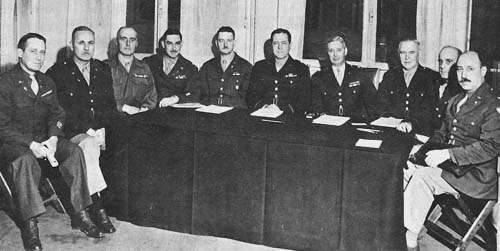 Photo:  The Ordnance Conference in Paris, February 1945.  Left to right, Colonel Lynde, Fifteenth Army; Colonel Wilson, 6th Army Group; Colonel Le Troadec, 1st French Army; Colonel Medaris, First Army; Colonel Nixon, Third Army; General Saylor, Chief Ordnance Officer, ETO; General Frank, Deputy Chief Ordnance Officer, ETO; General Nisley, 12th Army Group; Brig. Gen. Edward W. Smith, Seventh Army; Col. G.S. Kennedy, representing Colonel Warner, Ninth Army.