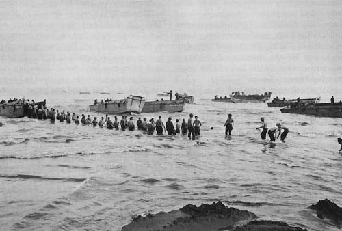 Photo:  Lined up to pass ammunition ashore, Lingayen Gulf, Luzon
