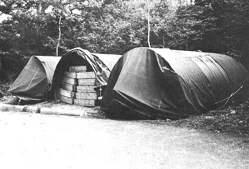 Photo:  Ammunition stored in hutments by an English roadside