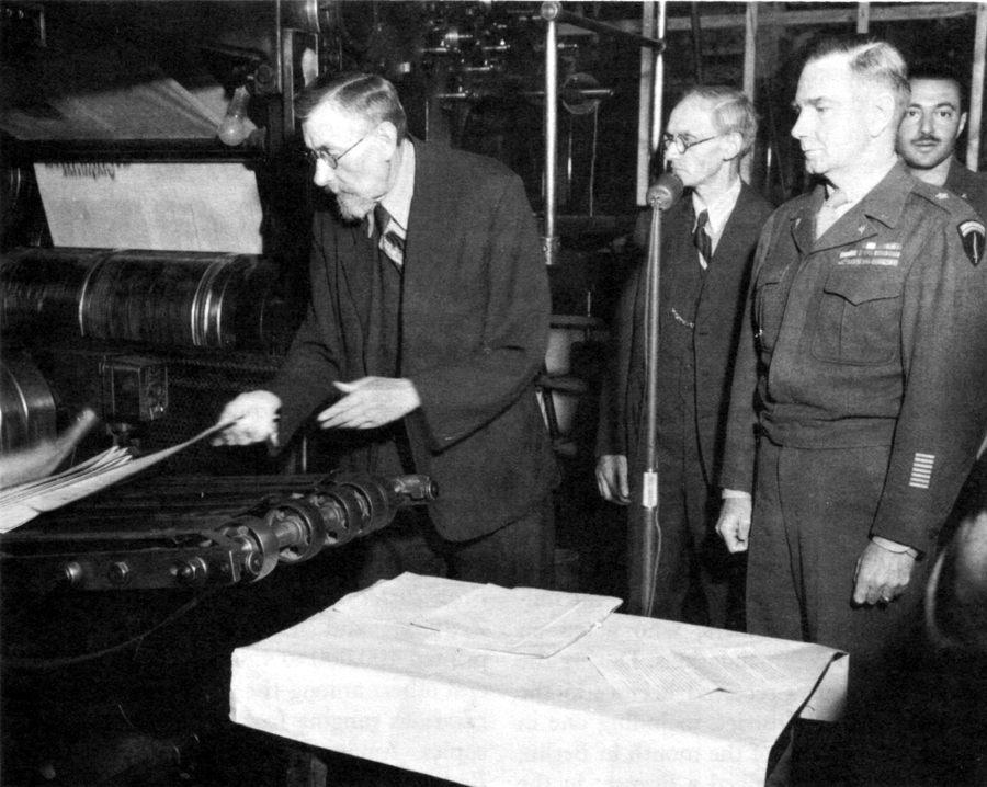 FIRST LICENSED NEWSPAPER COMES OFF PRESS. On the left Editor Hollands of the "Aachener Nachrichten." General McClure on the right.
