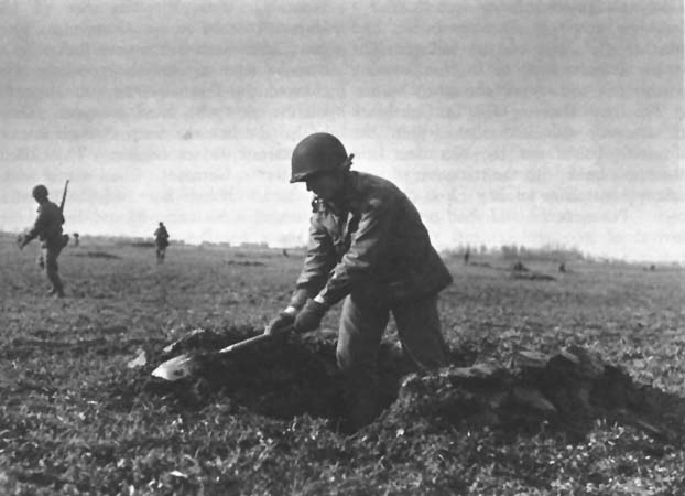 Photo: Men of the 104th Division dig foxholes near Standdaarbuiten. 