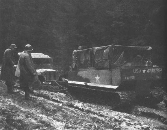 Photo: Weasel (M29 Cargo Carrier), similar to those usedfor evacuating wounded, pullsjeep out of the mud. 