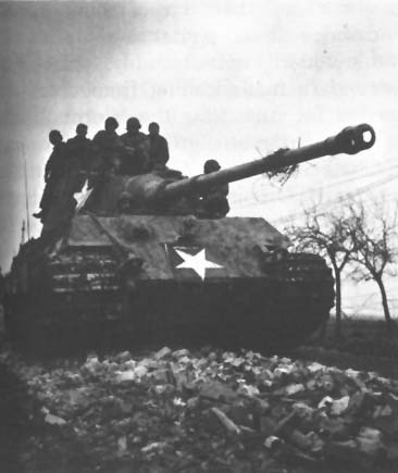 Photo: Captured German Tiger (Mark VI) Tank with temporary U.S. markings. Note 88-mm. gun with flash hider.