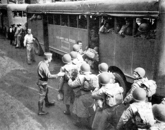 ARRIVING IN SYDNEY, AUSTRALIA, on 12 May 1944, above. Two days later members of the first contingent board buses for their new camp at Yeronga Park.