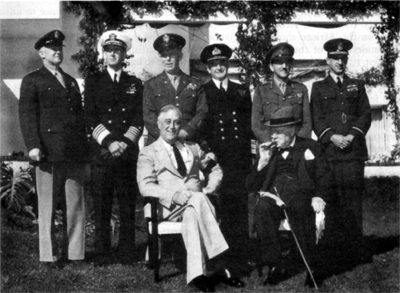BRITISH AND AMERICAN LEADERS AT CASABLANCA. Seated: President Franklin D. Roosevelt and Prime Minister Winston S. Churchill. Standing from left: Lt. Gen. Henry H. Arnold, Admiral Ernest,f. King, General George C. Marshall, Admiral of the Fleet Sir Dudley Pound, Field Marshal Sir Alan Brooke, and Air Chief Marshal Sir Charles F. A. Portal.
