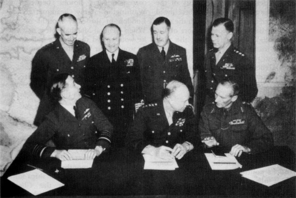 SUPREME COMMANDER, ALLIED EXPEDITIONARY FORCE, and his principal subordinates, London, r February zg.l¢. Seated from left: Air Chief Marshal Sir Arthur W. Tedder, General Eisenhower, General Sir Bernard L. Montgomery. Standing from left: Lt. Gen. Omar N. Bradley, Admiral Sir Bertram Ramsey, Air Marshal Sir Trafford Leigh-Mallory, and Lt. Gen. Walter Bedell Smith. Missing from the group is Lt. Gen. Carl A. Spaatz.