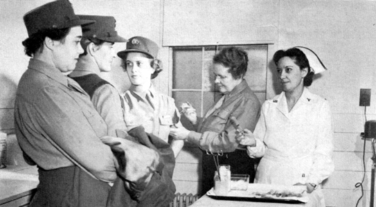 PROCESSING FOR OVERSEAS. Members of the first WAAC unit to go overseas receive their immunization shots.