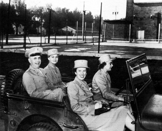 FIRST OFFICER EMILY E. DAVIS, right foreground, with Colonel Hobby and Colonel McCoskrie on a tour of Fort Des Moines in June 1943.