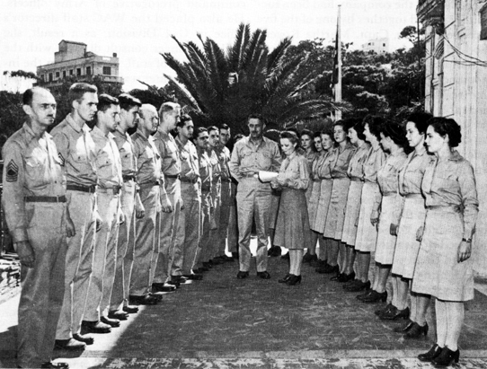MAJ. WESTRAY BATTLE BOYCE, WAAC Staff Director, North African Theater, reads orders replacing enlisted men of the adjutant general's office with enlisted women, Algiers, North Africa.