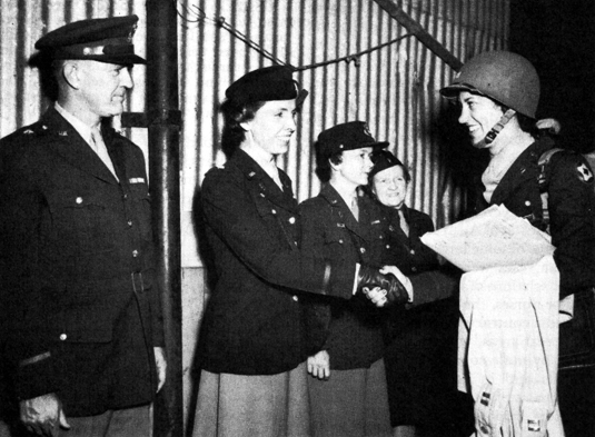 COMMANDING OFFICER OF THIRD CONTINGENT OF WACS to arrive in Australia is greeted at the pier on 10 July 1944. In the group greeting Capt. Ida M. Ross from left to right are Brig. Gen. Homer C. Brown, Lt. Col. Mary-Agnes Brown, Capt. Charlee L. Kelly and Lt. Vera Mankinen.