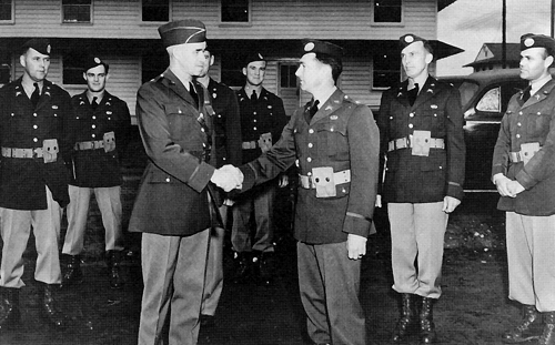 Photo:  Brig. Gen. Omar Bradley, commander of the Infantry School at Fort Benning, congratulates newly qualified parachute officers of the 501st Parachute Infantry Battalion in 1941. Bradley vigorously pursued the development of airborne forces and was instrumental in the development of the Officer Candidate School system that would produce thousands of officers during World War II. 