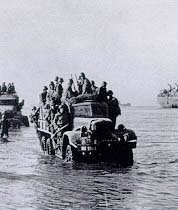 Men and equipment move ashore south of Anzio on D-day.