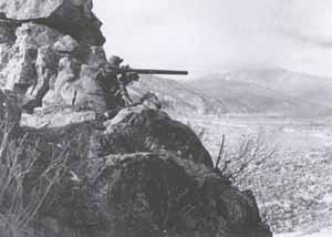A U.S. infantryman with a 75-mm recoilless rifle (rocket launcher) guards a  pass south of the Chosin Reservoir. 