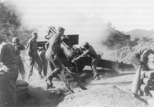 Photo: Soldiers of Battery C, 936th Field Artillery Battalion, fire at Communist positions near Ch'orwon