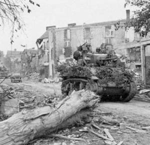 U.S. tanks pass through the Wrecked streets of Coutances.