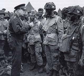 Photograph, General Eisenhower talks with men of Company E, 502d Parachute Infantry Regiment, at the 101st Airborne Division's camp at Grenham Common, England, 5 June 1944.