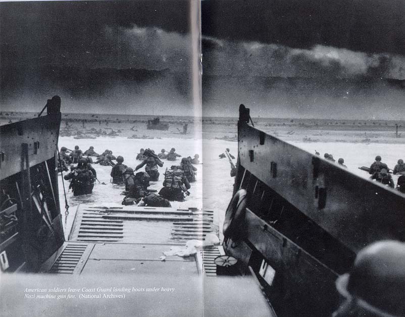 Photograph, American soldiers leave Coast Guard landing boats under heavy Nazi machine gun fire.