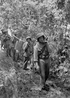 Men of the 148th Infantry carry hot food forward.